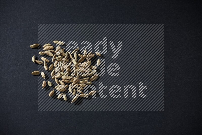 Cardamom seeds on black flooring