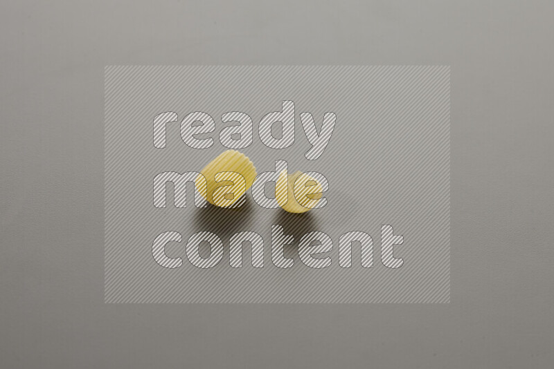 Big rings pasta with other types of pasta on grey background