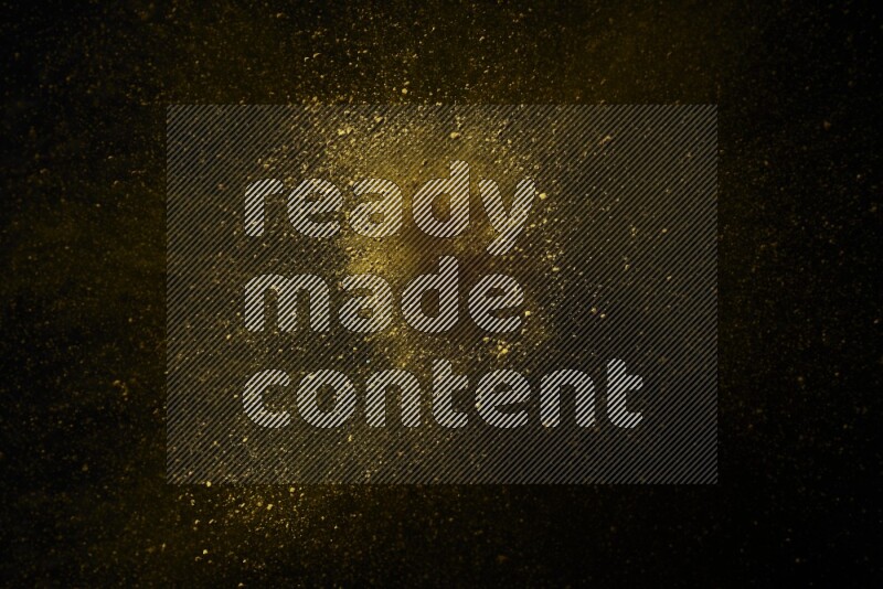 Yellow powder explosion on black background
