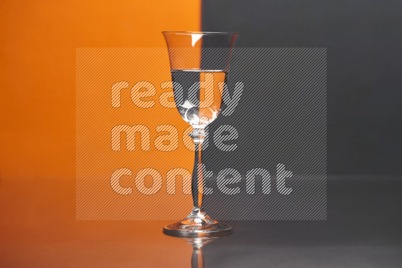 The image features a clear glassware filled with water, set against orange and black background