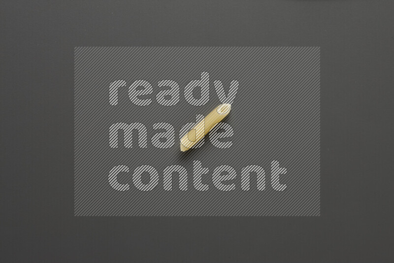 Mini penne pasta on grey background