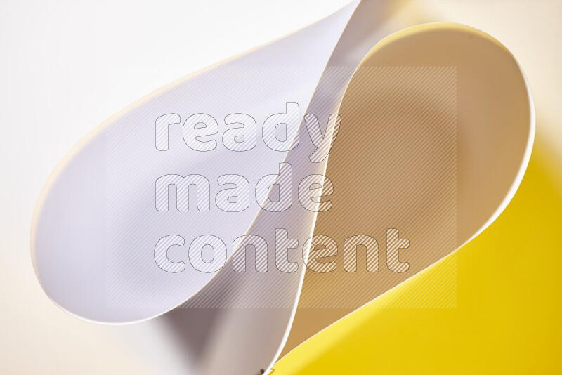 An abstract art of paper folded into smooth curves in white and yellow gradients