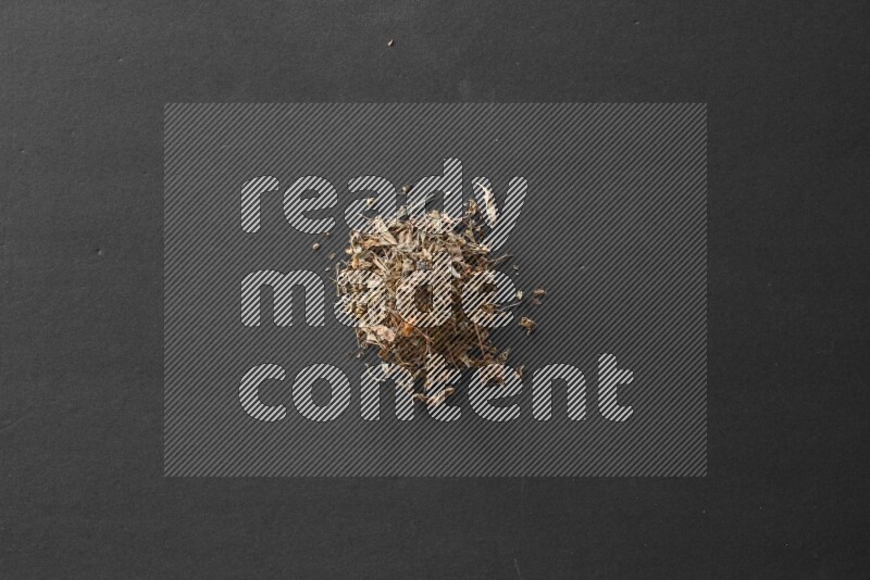 Dried basil on a black flooring