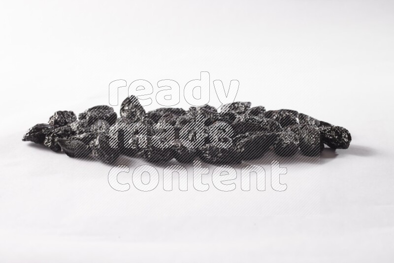 Dried plums on white background