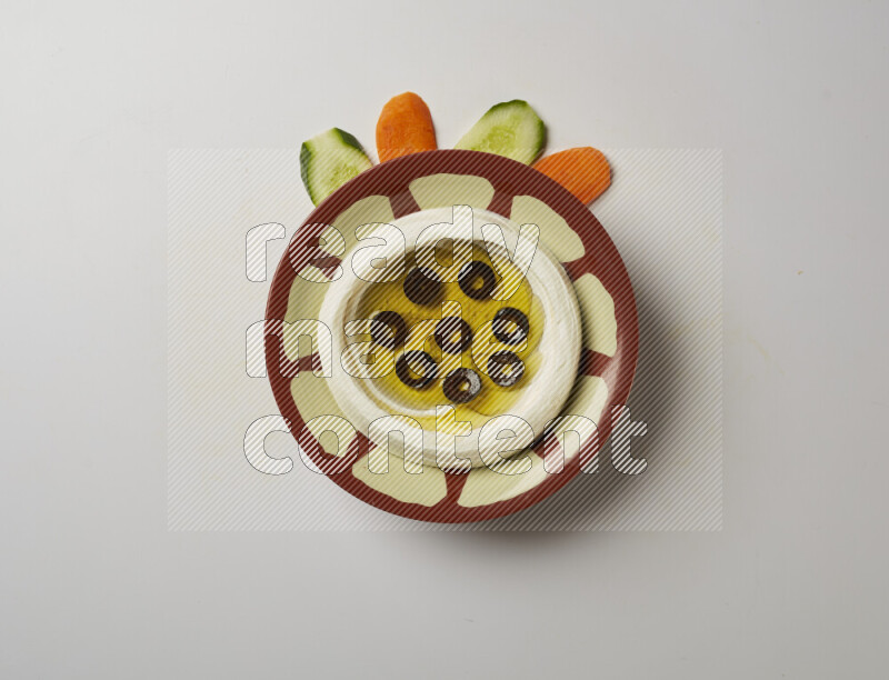Lebnah garnished with sliced olives in a traditional plate on a white background