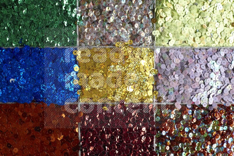 Multicolored flat sequins on grey background