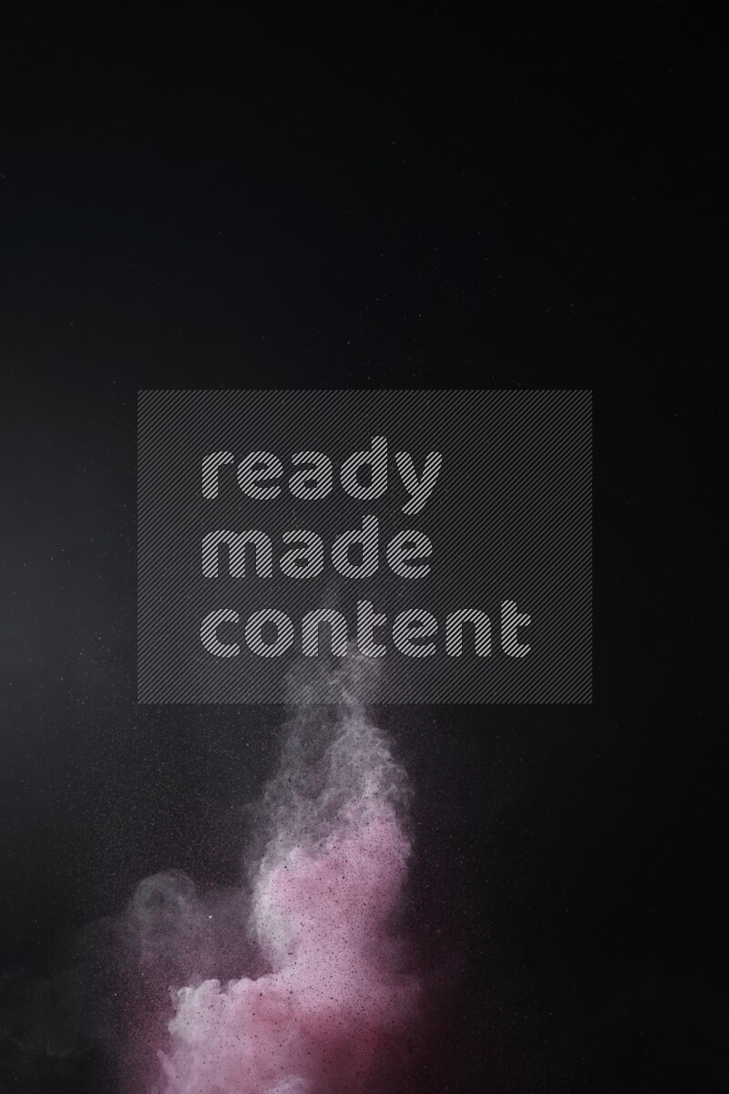 A side view of red powder explosion on black background