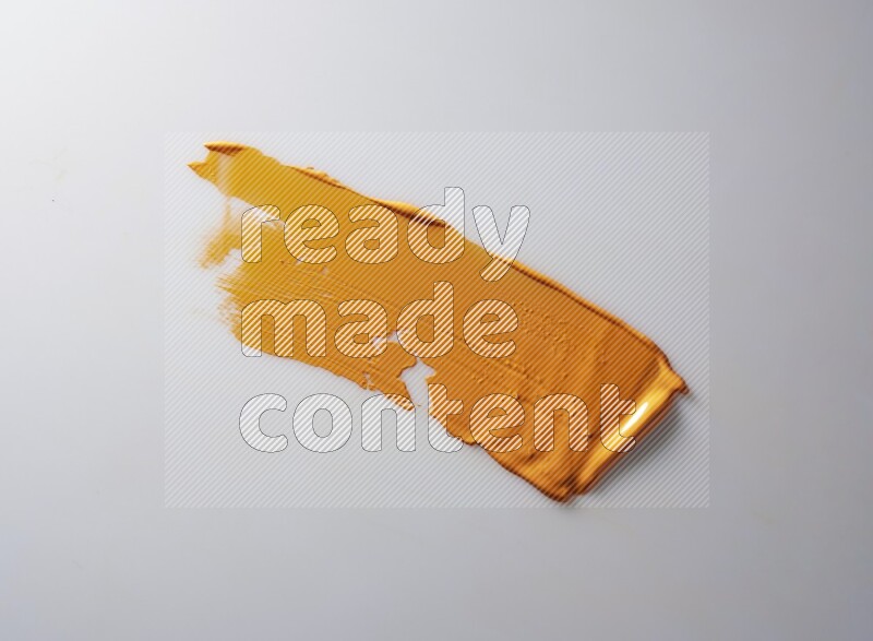 An orange straight painting knife stroke on white background
