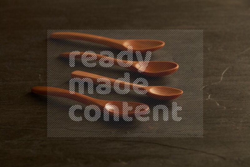 wooden spoon on black slate background