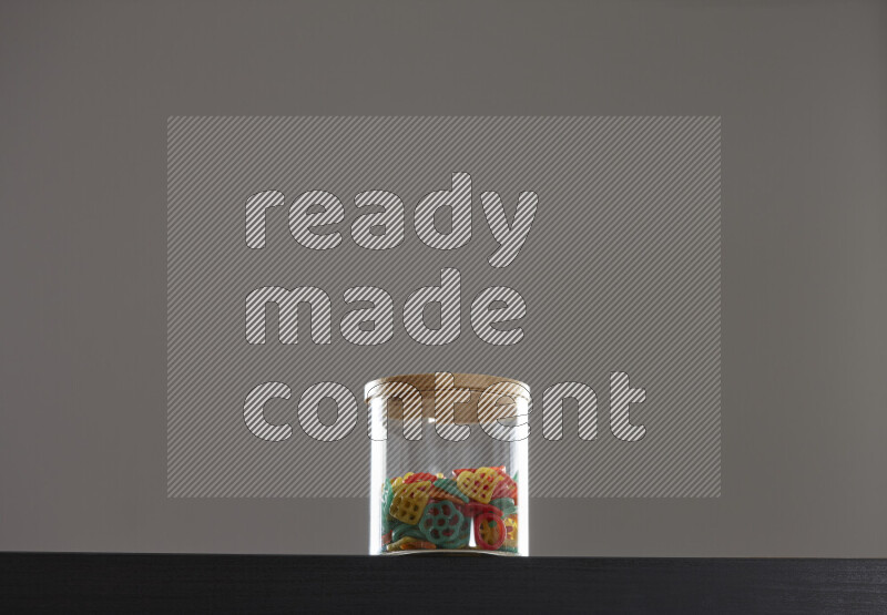 Snacks in a glass jar on black background