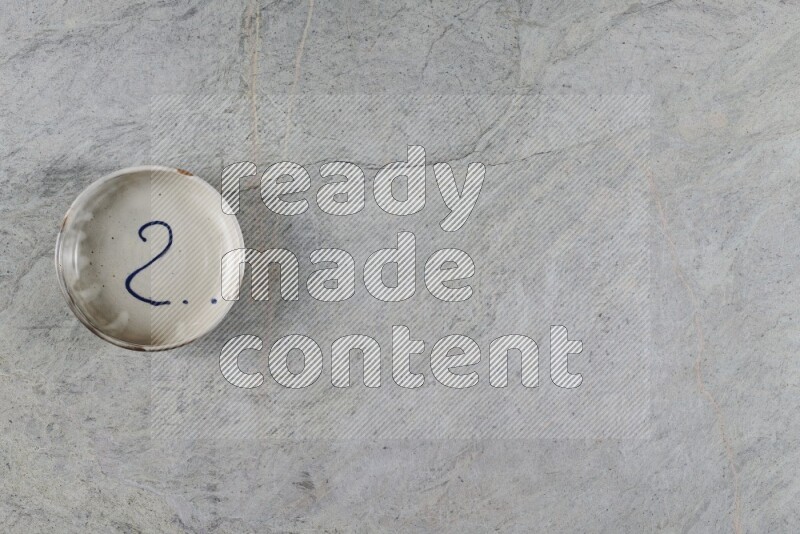 A multicolored pottery Bowl on grey marble background