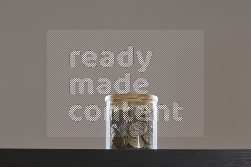 Buttons in a glass jar on black background