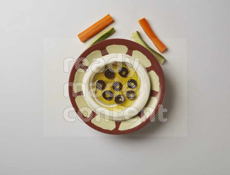 Lebnah garnished with sliced olives in a traditional plate on a white background