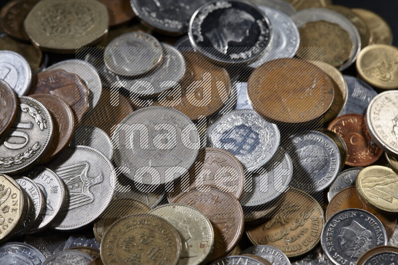 A close-ups of random old coins on black background