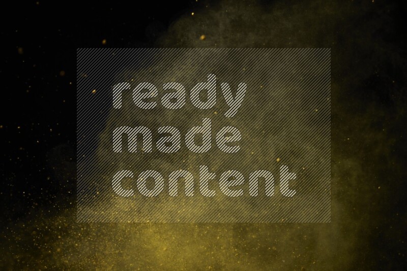 Yellow powder explosion on black background