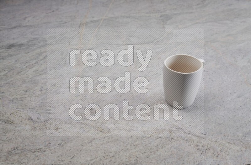 A white ceramic mug on grey marble background