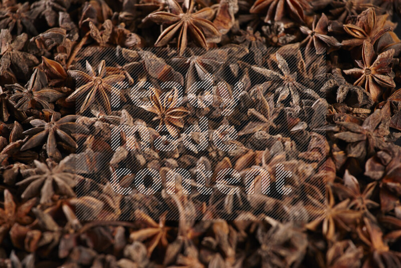 Star Anise fill the frame on black flooring