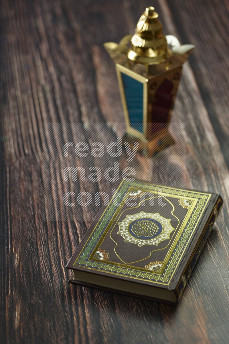 A golden lantern with different drinks, dates, nuts, prayer beads and quran on brown wooden background