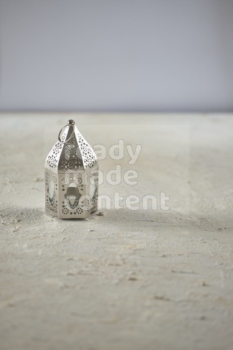A lantern placed on a textured white background