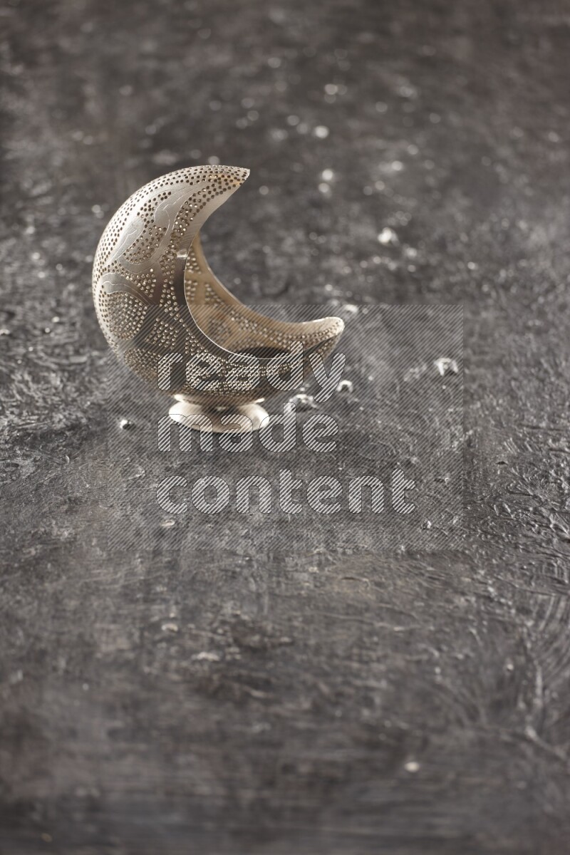 A lantern placed on a textured black background