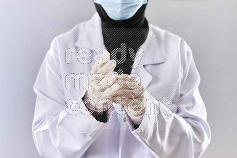 Female doctor wearing an abaya and medical attire in different positions