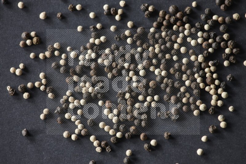 Mixed black and white pepper beads on a black flooring
