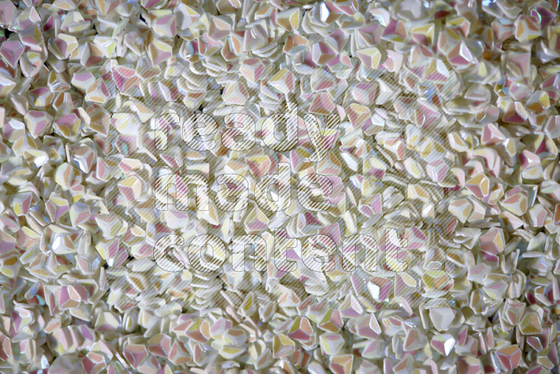 Colorful plastic shards for decoration scattered on a black background