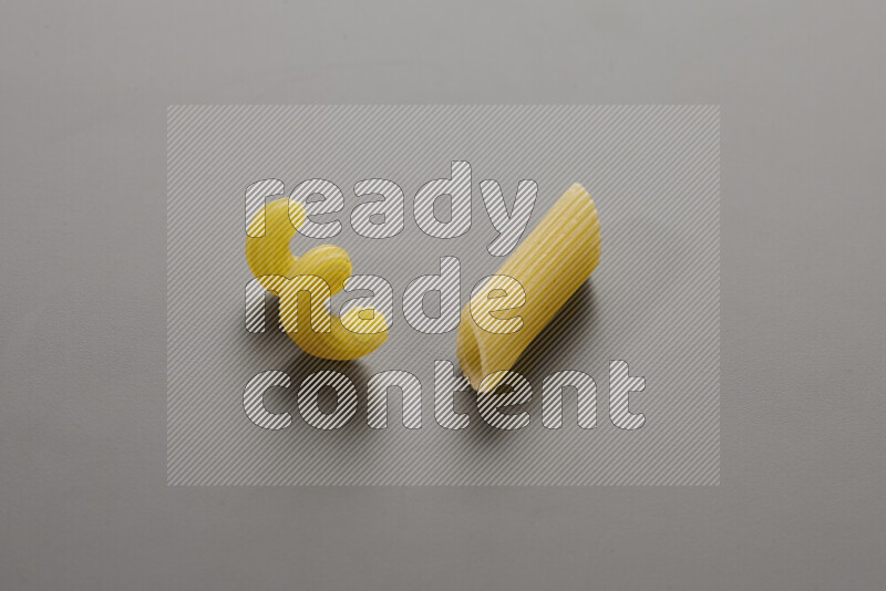 Twist pasta with other types of pasta on grey background