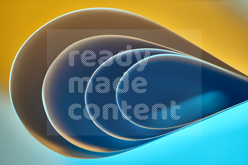 An abstract art of paper folded into smooth curves in blue and yellow gradients