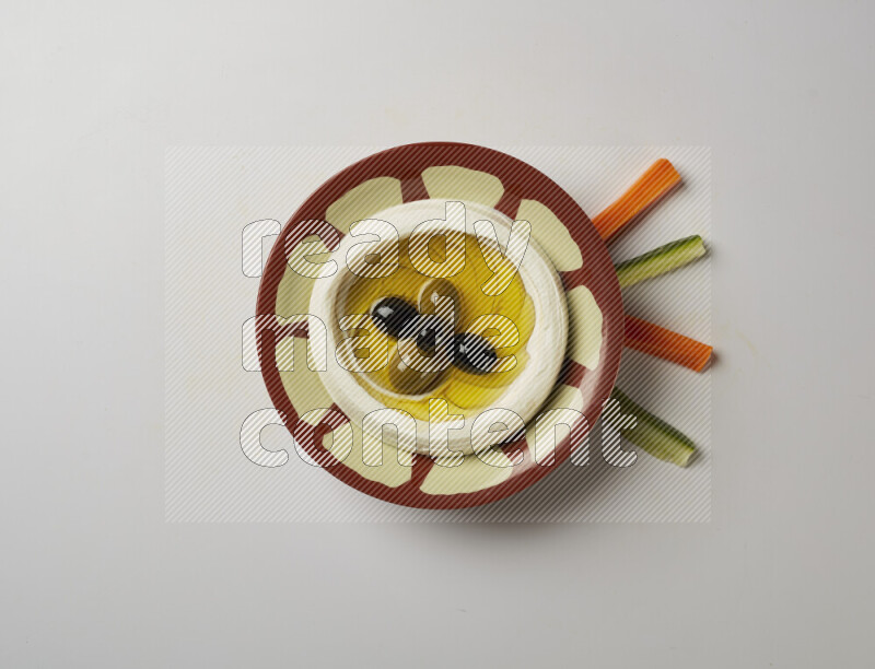 Lebnah garnished with olives in a traditional plate on a white background