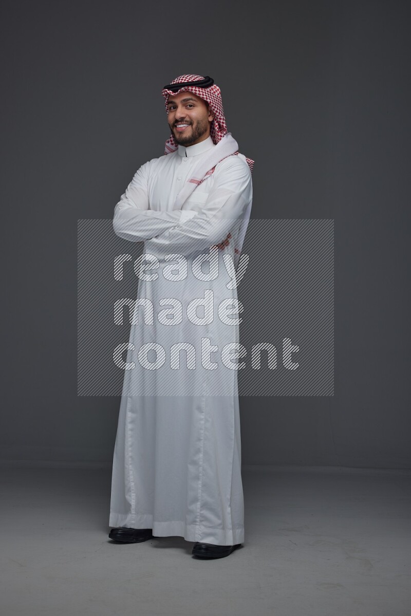 A Saudi man wearing Thobe and Shmagh standing in different poses eye level on a gray background