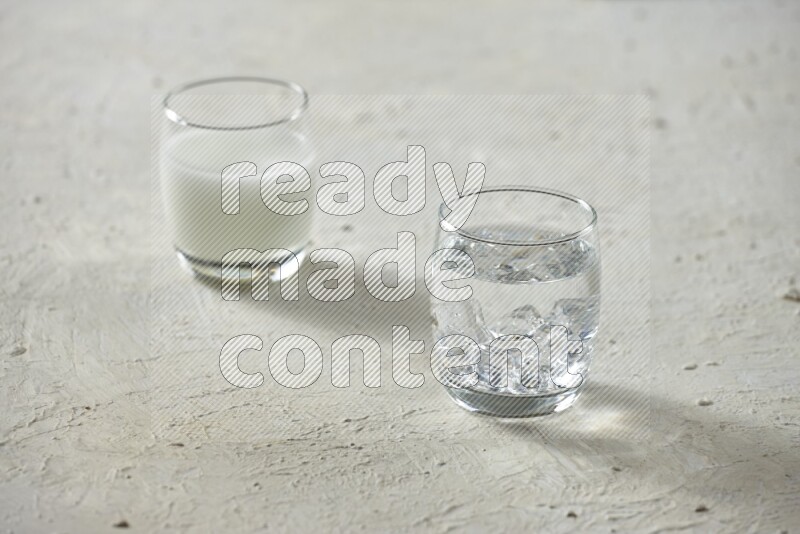 Cold drinks in a glass cup such as water, tamarind, qamar eldin, sobia, milk and hibiscus on textured white background