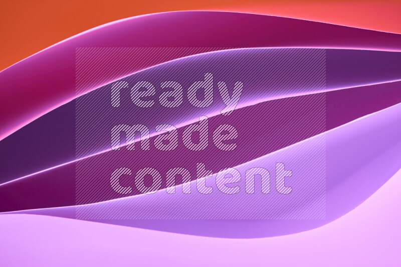 هذه الصورة تعرض تكوين فن الورق التجريدي مع منحنيات ورقية بتدرجات لونية دافئة مختلفة المكونه بواسطة الضوء الملون