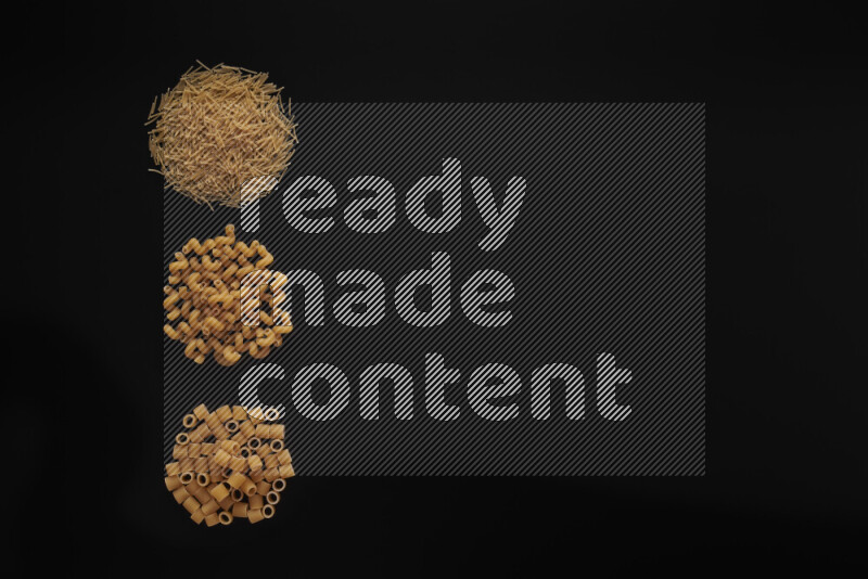 Different pasta types in 3 bunches on black background