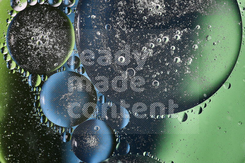 Close-ups of abstract oil bubbles on water surface in shades of green and blue