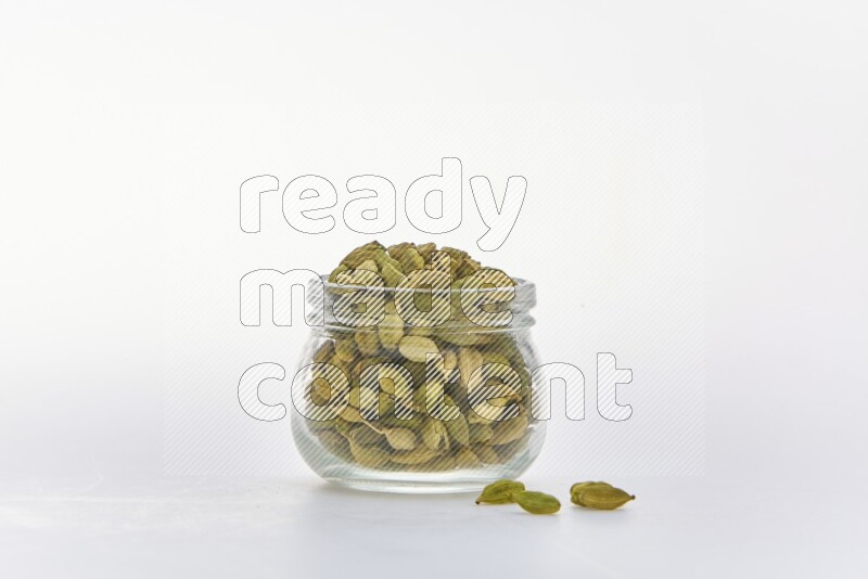 Cardamon in a container on white background