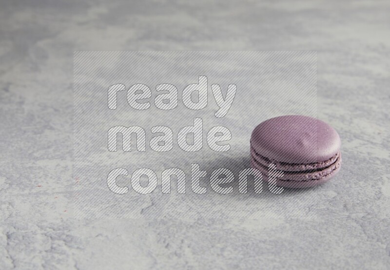 45º Shot of Purple Blueberry macaron on white  marble background