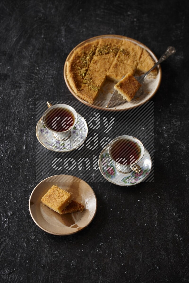 konafa with tea in a dark setup