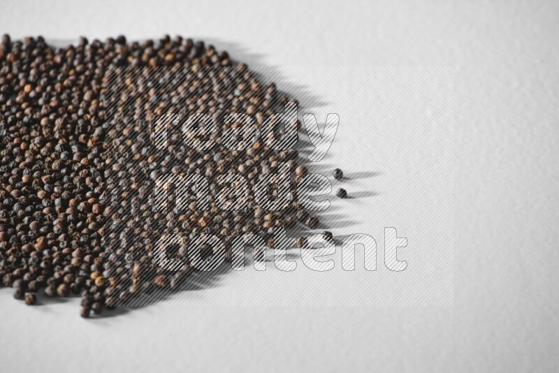 Black pepper on a white flooring