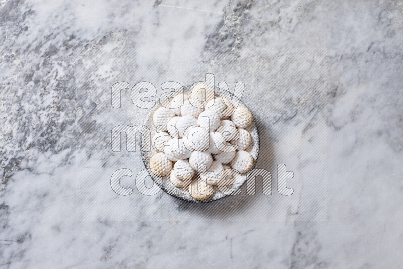 Kahk in black pottery plate on grey marble background