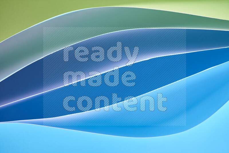 This image showcases an abstract paper art composition with paper curves in green and blue gradients created by colored light