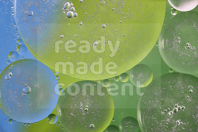 Close-ups of abstract oil bubbles on water surface in shades of green and blue