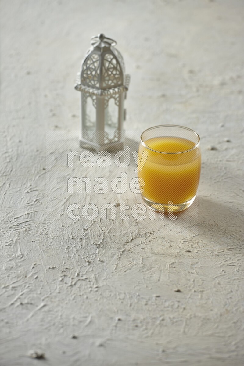 A white lantern with different drinks, dates, nuts, prayer beads and quran on white background