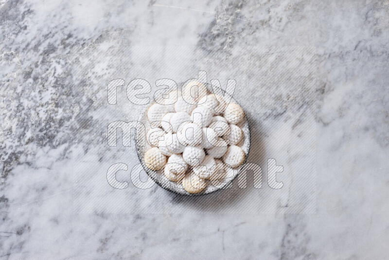 Kahk in black pottery plate on grey marble background