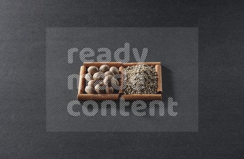 2 squares of cinnamon sticks full of nutmeg and white peppers on black flooring