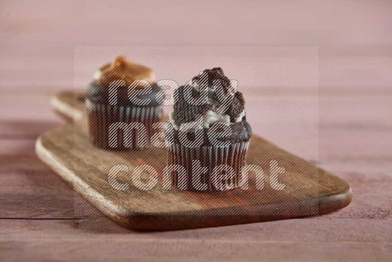 Chocolate mini cupcake topped with oreo on a wooden board