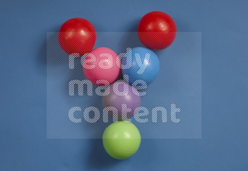 Multicolored plastic balls on different colored backgrounds (kids toys)
