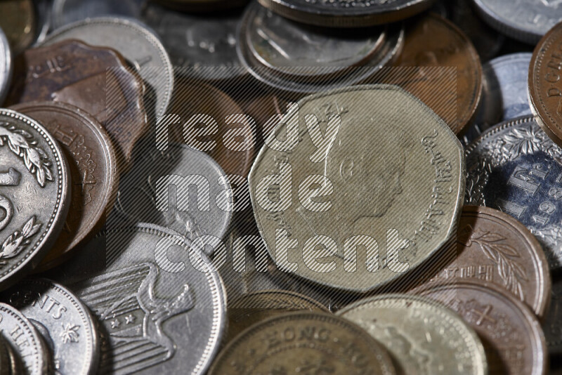 A close-ups of random old coins on black background