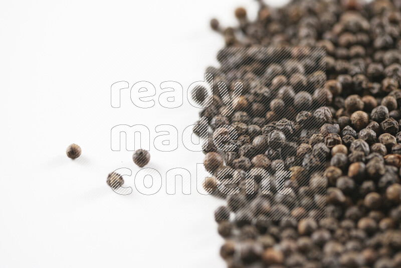 Black pepper beads on white background