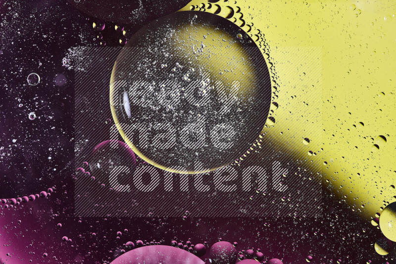 Close-ups of abstract oil bubbles on water surface in shades of yellow and pink